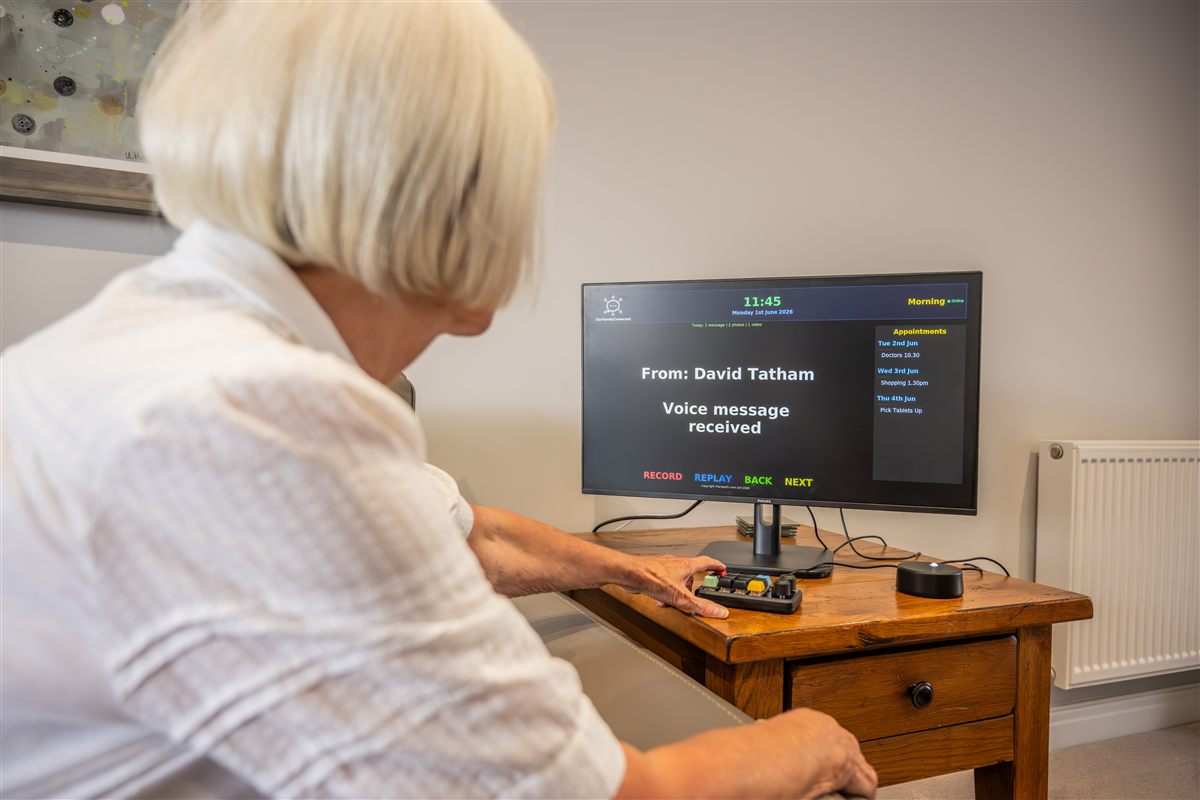 Elderly woman pressing the coloured keypad buttons